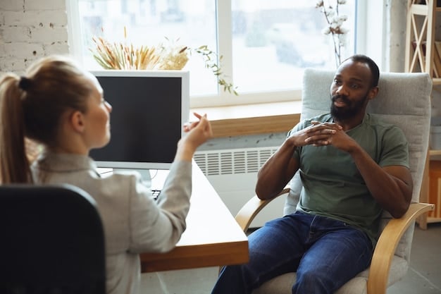 A cheerful therapist is conducting a telehealth session with a young adult African American male. Both are smiling. The setting is a well-lit and comfortable room.