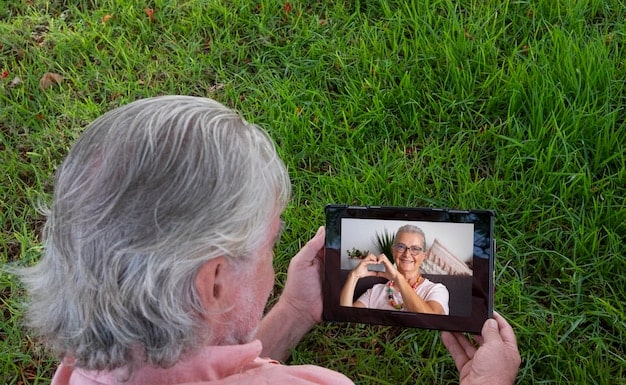 A senior patient in a rural area using a tablet to consult with a doctor via telehealth, highlighting the ease of use and accessibility of the technology for older adults.